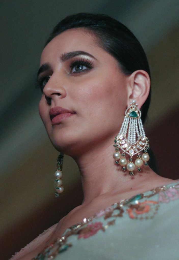 Portrait of a woman in traditional attire adorned with elegant jewelry, showcasing fashion and style.
